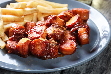 Traditional German currywurst - pieces of sausage with curry sauce