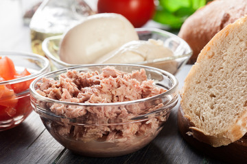 Ingredients ready for preparing bruschetta with tuna, mozzarella cheese and tomatoes