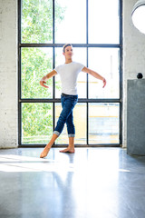 Fototapeta na wymiar A handsome young male Ballet dancer practicing in a Loft style A