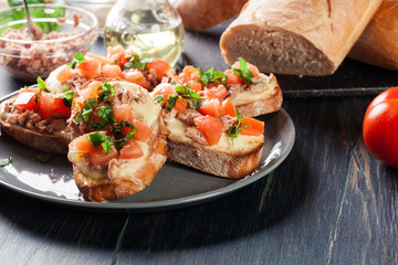 Appetizer bruschetta with tuna, mozarella cheese and tomatoes