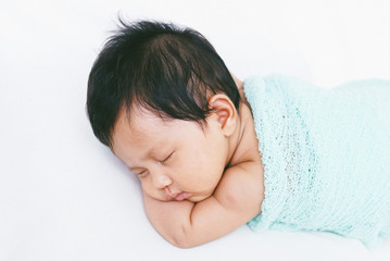 Fototapeta na wymiar Newborn Baby Sleeping Peacefully Over White Bed 