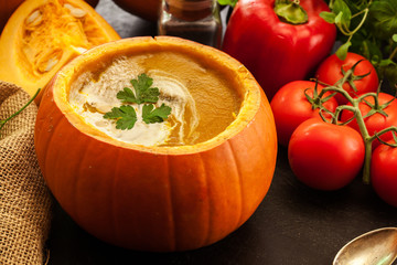 Pumpkin soup with cream in a pumpkin