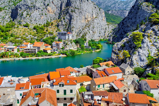 Coastal town of Omis surrounded with mountains in Croatia, Croatian travel landmark at Adriatic sea