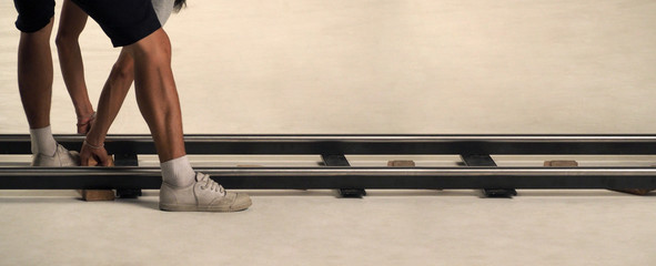 Production crew setting dolly track in studio.