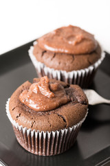 Selective focus on chocolate cup cake muffin on the black square plate