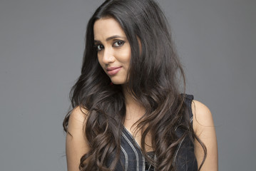 Portrait of cute Indian woman wearing black dress with black hair