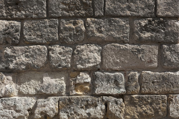 Medieval Old wall from a stone brick of gray color