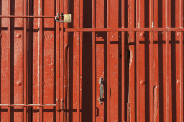 Old style of close red steel door. The old Rusty steel door