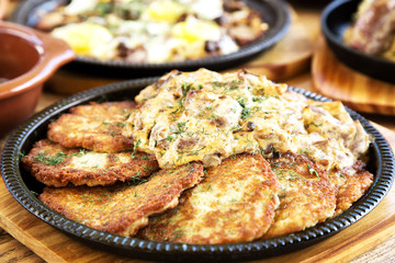 Tasty hash browns with meat in sauce