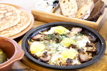 Eggs with bacon on a frying pan