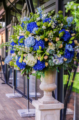 Beautiful flower arrangement (bouquet) of blue hydrangea, orchid and rose