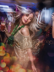 Female in night club in blurred motion. Stylish lady at Christmas discotheque, New Year company,...