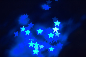 abstract background with star shaped bright blue bokeh and space