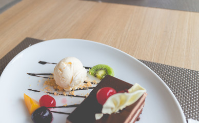 chocolate layer cake and vanilla ice cream with fresh fruit and cherry