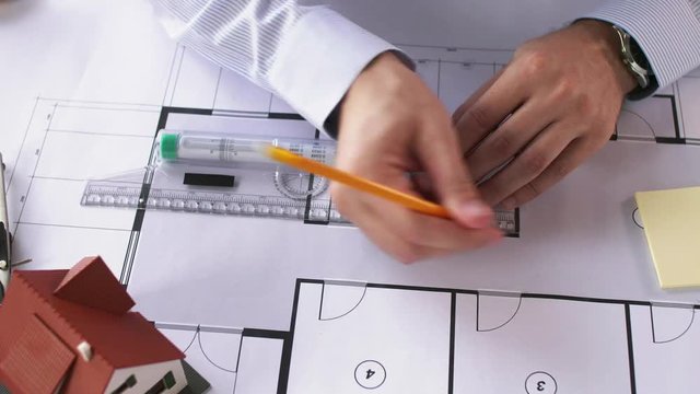 architect hands with ruler measuring blueprint