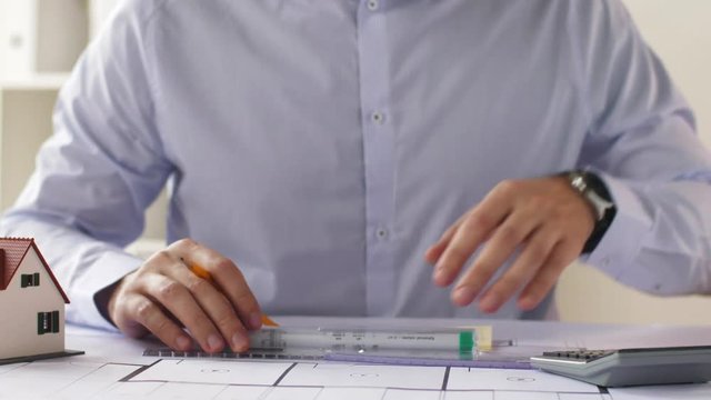 architect hands with ruler measuring blueprint
