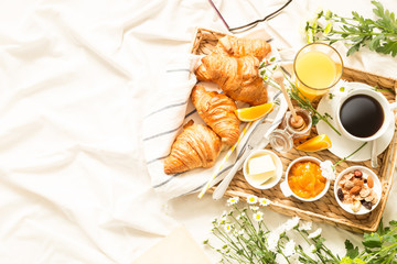 Continental breakfast on white bed sheets - flat lay - obrazy, fototapety, plakaty