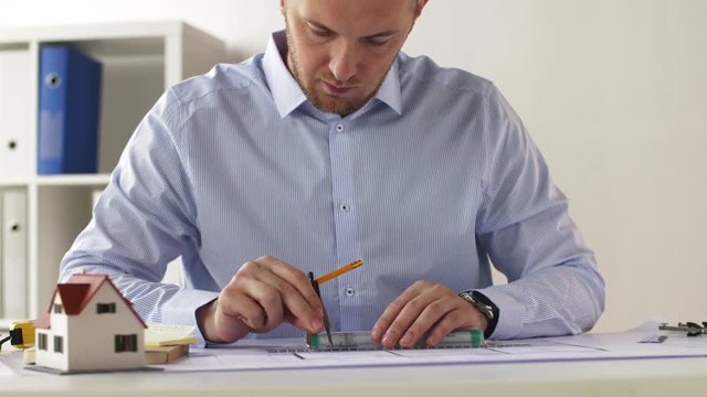 architect with ruler, compass and blueprint