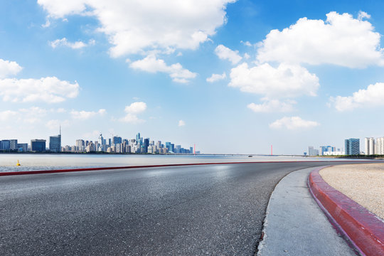 empty asphalt road with cityscape of modern city