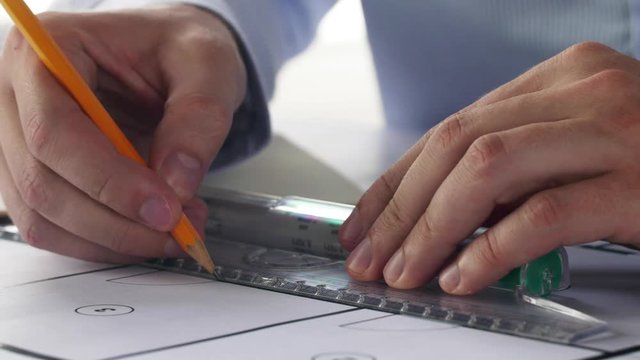 architect hands with ruler measuring blueprint