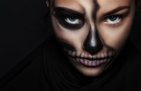 Closeup girl face with make-up skeleton. Halloween portrait.