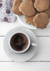 Coffee and cookies on white wooden table