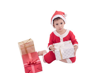 Asian kid dress up as santa claus with gift boxes .