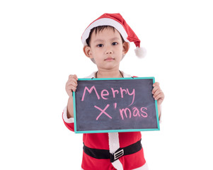 Asian kid dress up as santa claus. In his hand holding the black board .