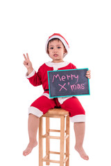 Asian kid dress up as santa claus. In his hand holding the black board .