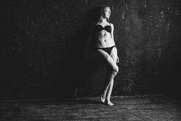 Beautiful girl posing in studio on dark background