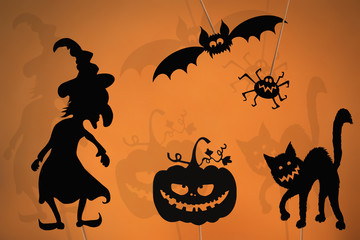 Shadow puppets of Halloween monsters.
