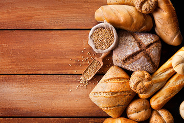 Bread on wooden table, top view.