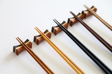 Beautiful collection of wooden chopsticks isolated on white background