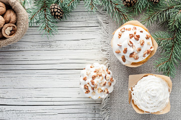 christmas decorated cupcakes on white wooden background top view