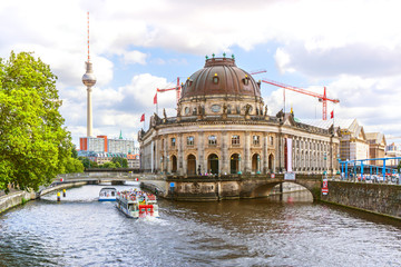 Berlin with Bode museum and boats with tourists on a sightseeing tour on the River Spree