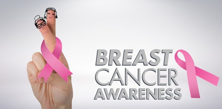 Composite image of cropped hand holding breast cancer awareness