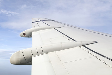 In flight point of view looking through the window at the airplane wing 
