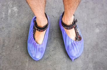 colorful hospital clean overshoes on mans legs in sandals