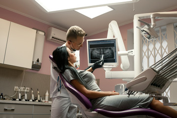 Female patient on reception at doctor in dental office.