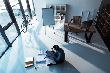 businessman in headphones working with papers