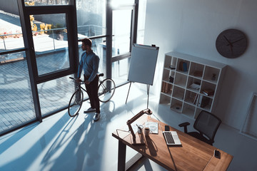 businessman with bicycle in office