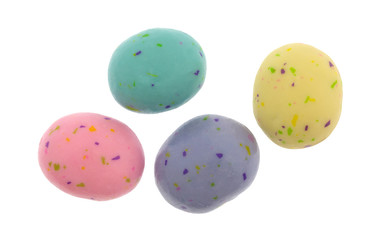 Top view of several speckled Easter egg malt ball candies isolated on a white background.