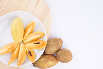 Sapodilla fruit on wooden isolated white background