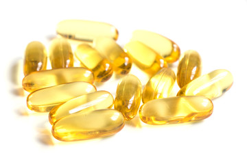 Yellow color soft gelatin capsule on white background (Concept of medicine, drug, nutrition supplement)