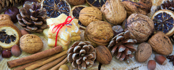 Christmas decoration with different nuts and cinnamon sticks.