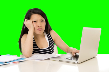 pretty asian woman student overworked on her laptop on green screen croma key