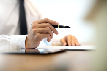 Business man hold pen on the air