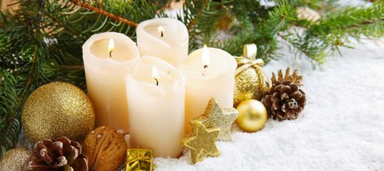 Four burning advent candles and Christmas decoration.