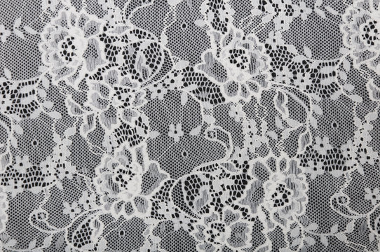 Fototapeta white floral lace on a black background
