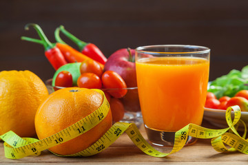 Healthy concept with mixed fruits and vegetables on wooden background